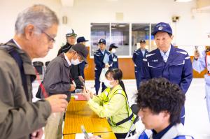 避難所での受付を視察する小菅市長の様子(写真)