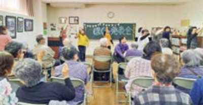 日頃の活動を成果を発表する様子（写真）笑顔で踊ったり、見ているひとは手拍子をしています