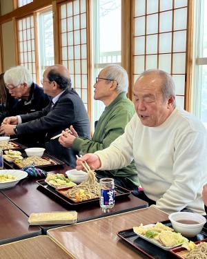 地域住民が集まってそばを食べる様子（写真）